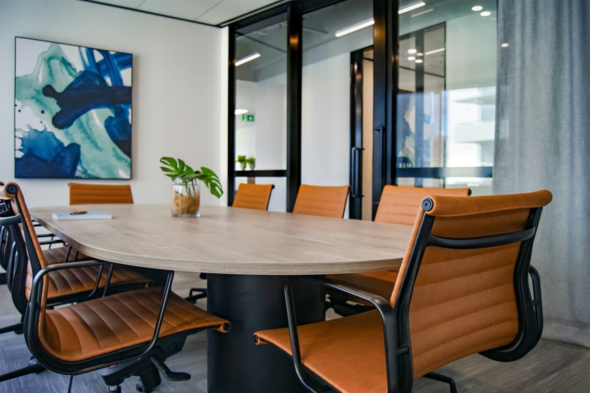Meeting room with painted walls, artwork and a long timber table
